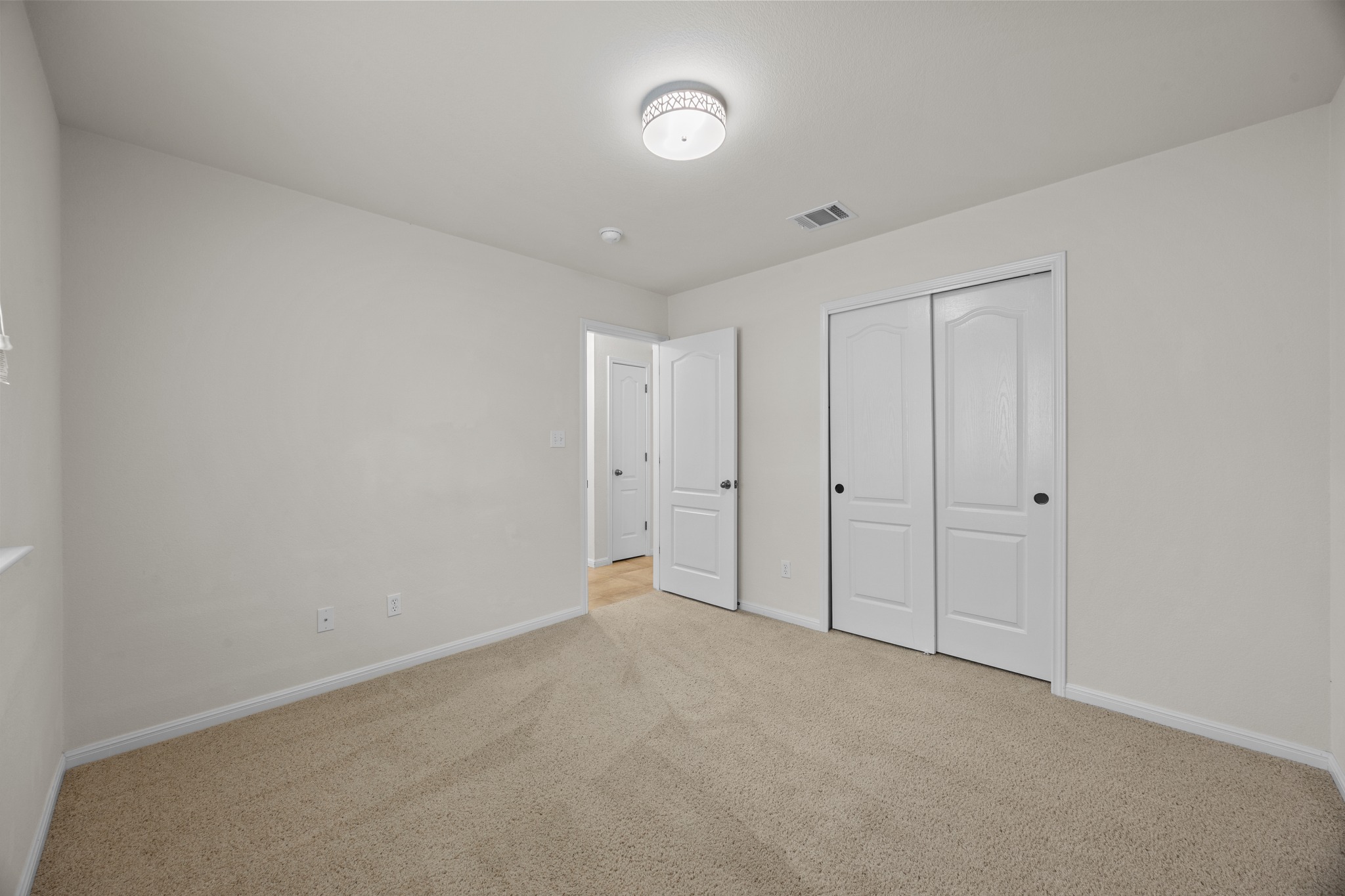 1317 Rimstone Drive Cedar Park, TX 78613 - Photo 8 of 32 Unfurnished bedroom with light colored carpet and a closet
