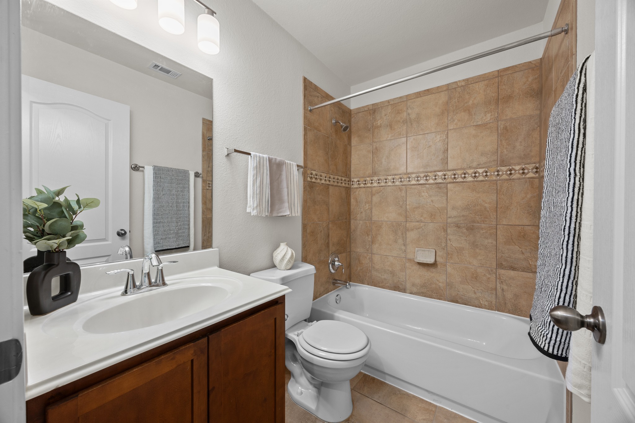1317 Rimstone Drive Cedar Park, TX 78613 - Photo 9 of 32 Bathroom featuring vanity, shower / bath combo, and light tile patterned floors