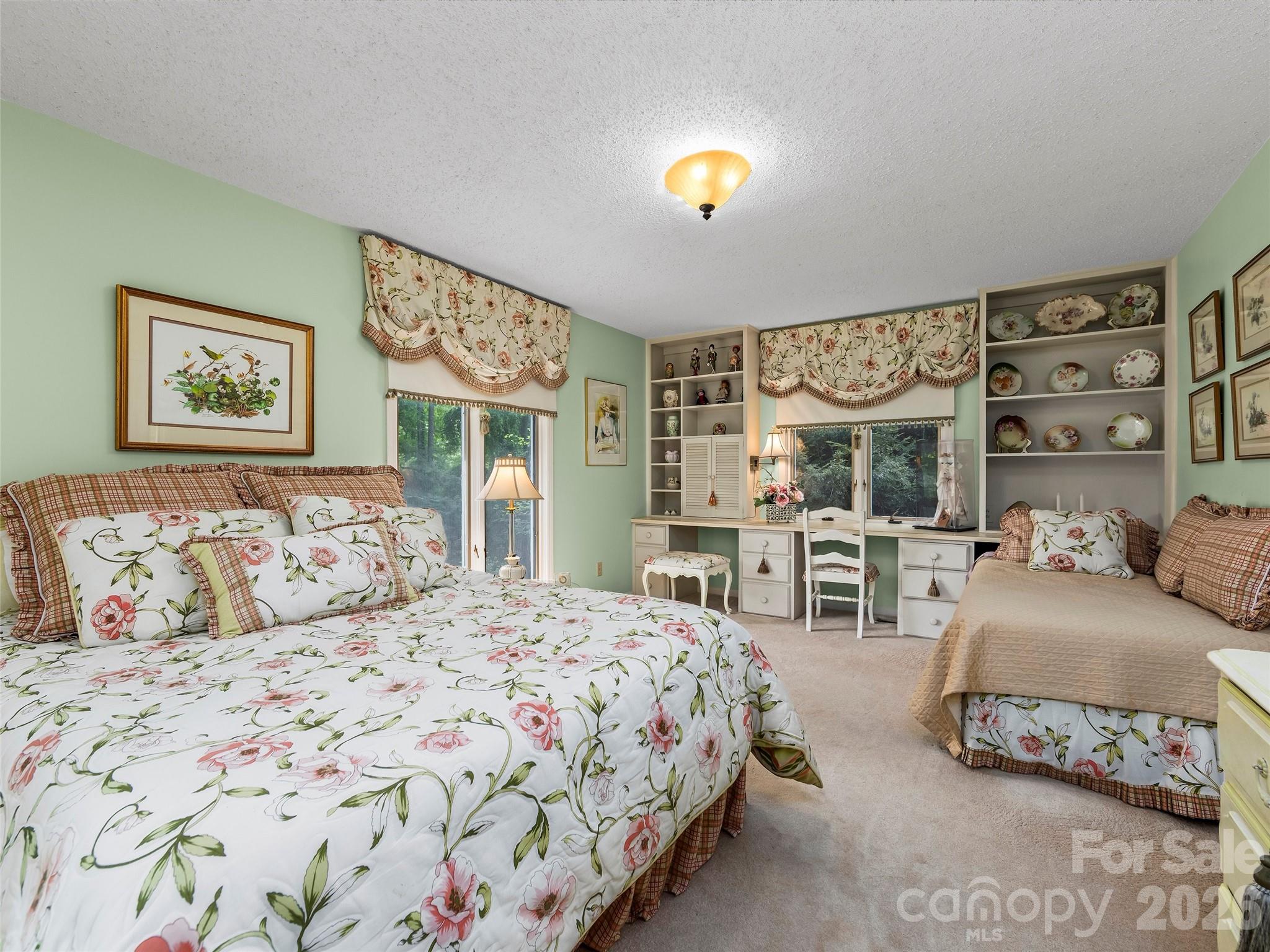 69 Forest Road Asheville, NC 28803 - Photo 24 of 48 a bedroom with a bed and a table in it