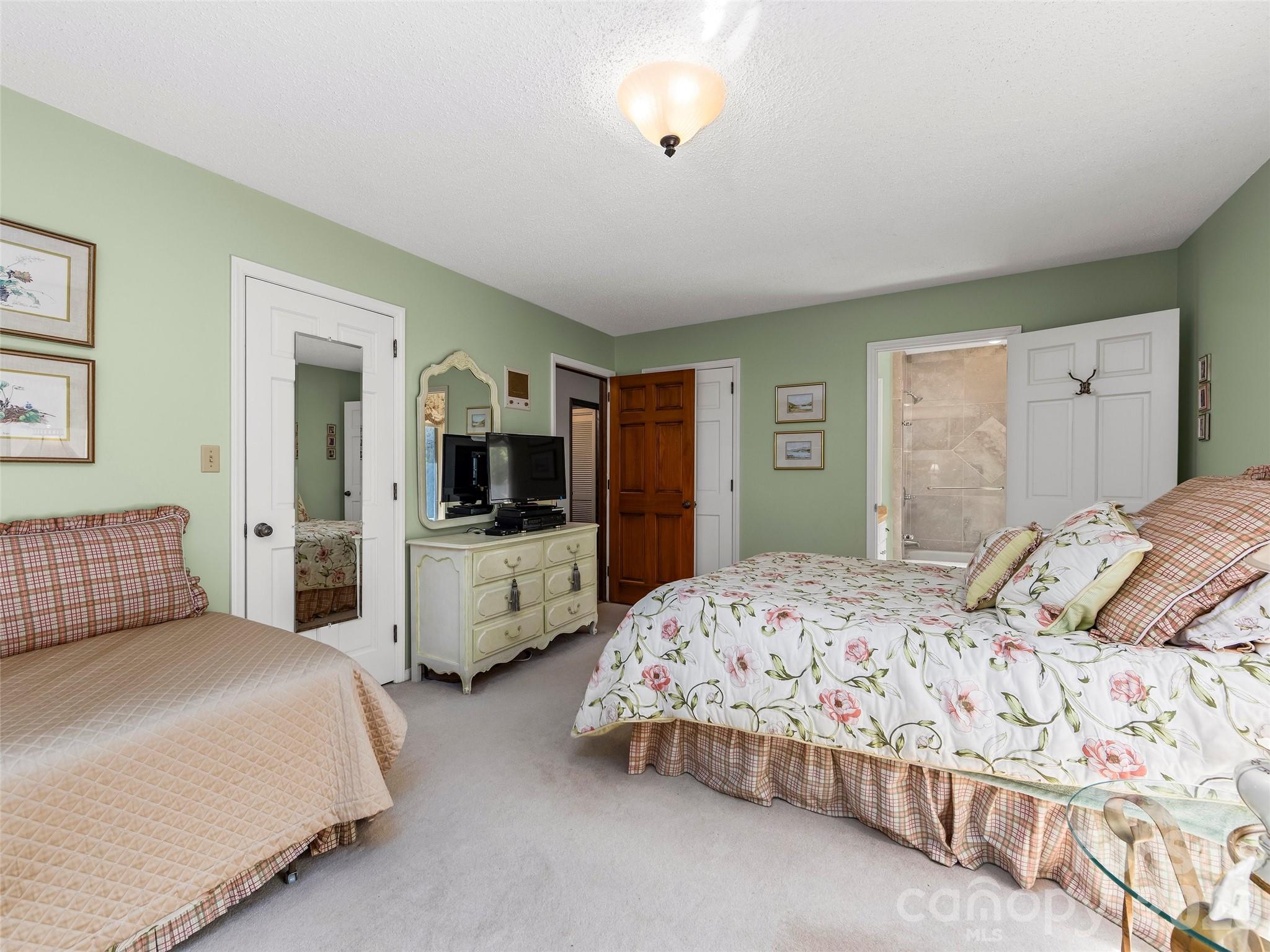 69 Forest Road Asheville, NC 28803 - Photo 25 of 48 a bedroom with double bed and a flat screen tv
