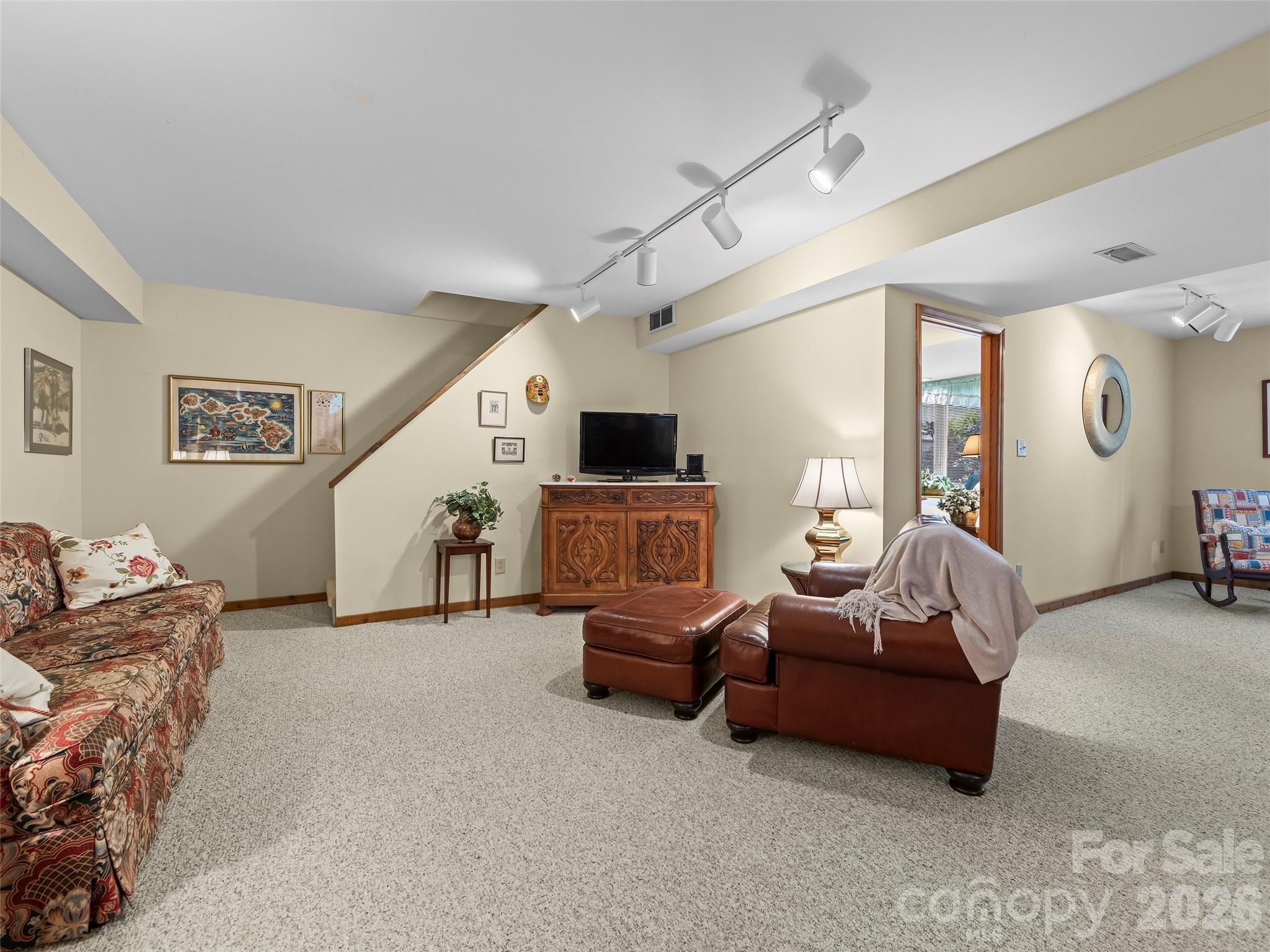 69 Forest Road Asheville, NC 28803 - Photo 31 of 48 a living room with furniture and a flat screen tv