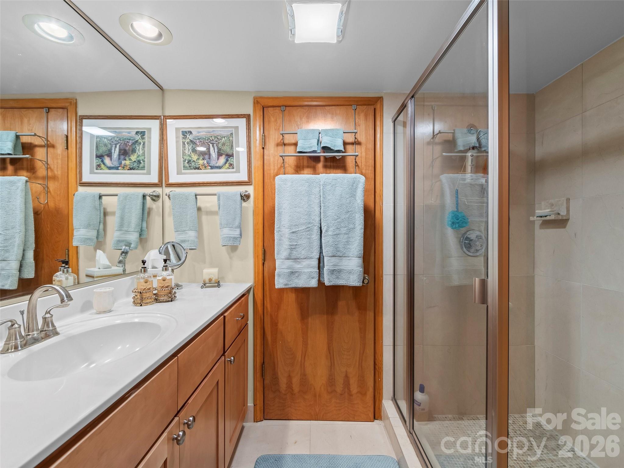69 Forest Road Asheville, NC 28803 - Photo 35 of 48 a bathroom with a double vanity sink and a mirror