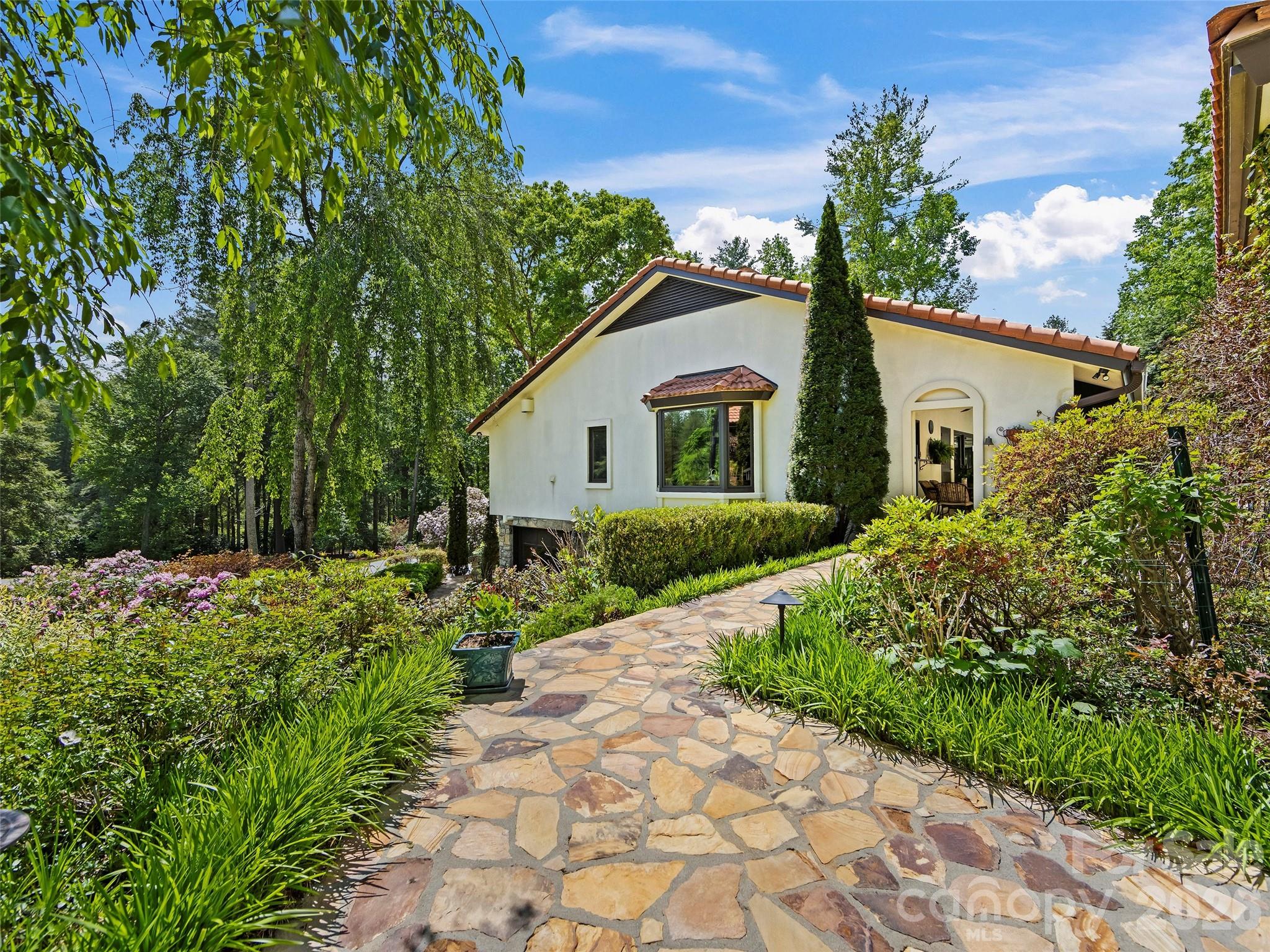 69 Forest Road Asheville, NC 28803 - Photo 43 of 48 a front view of a house with a yard and potted plants