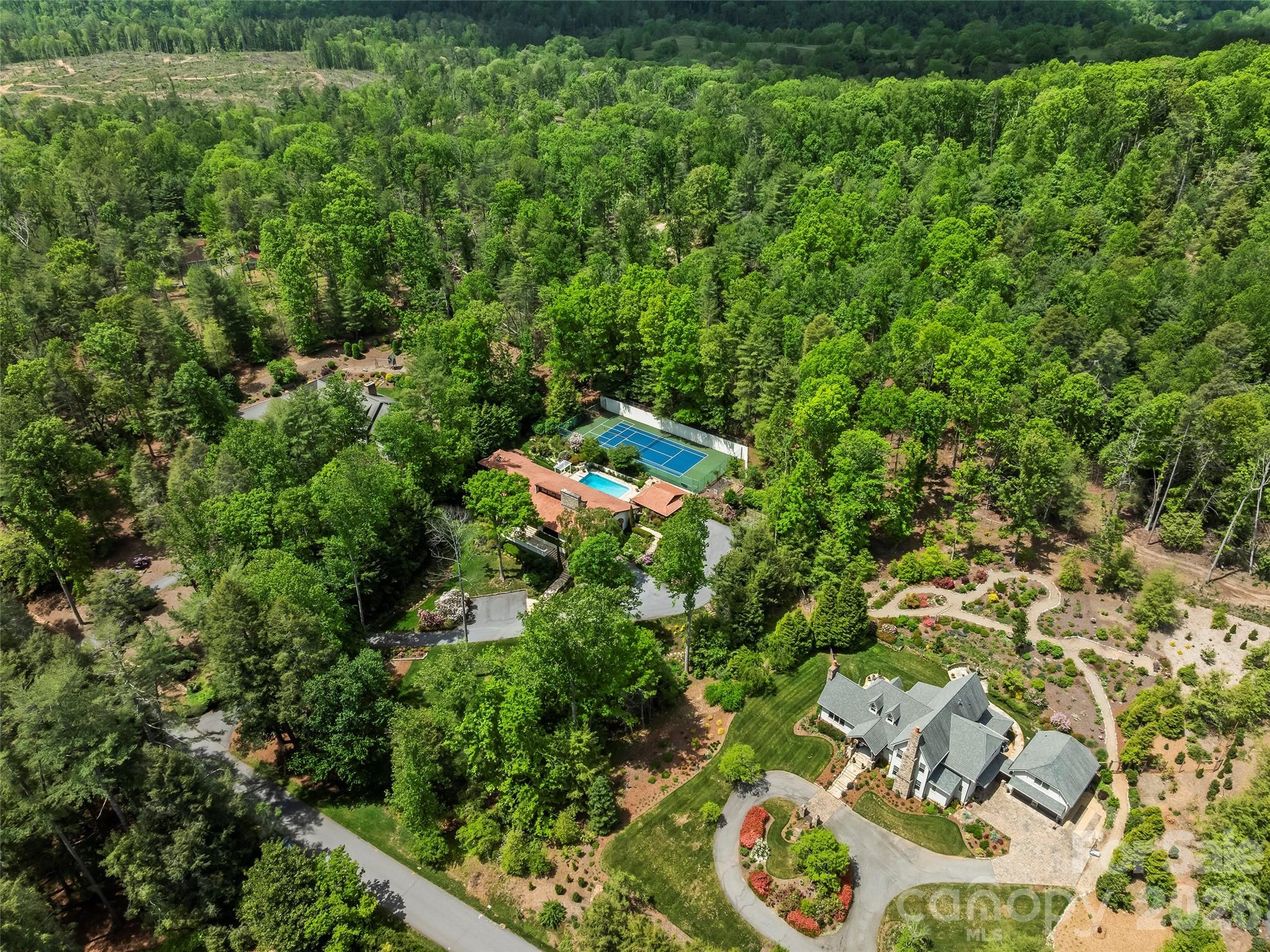 69 Forest Road Asheville, NC 28803 - Photo 48 of 48 an aerial view of residential house with outdoor space and trees all around