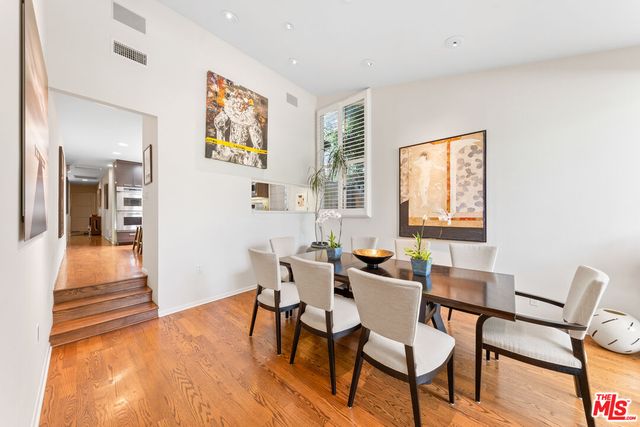 a dining room with furniture and wooden floor
