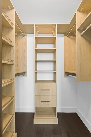 a view of walk in closet with empty racks