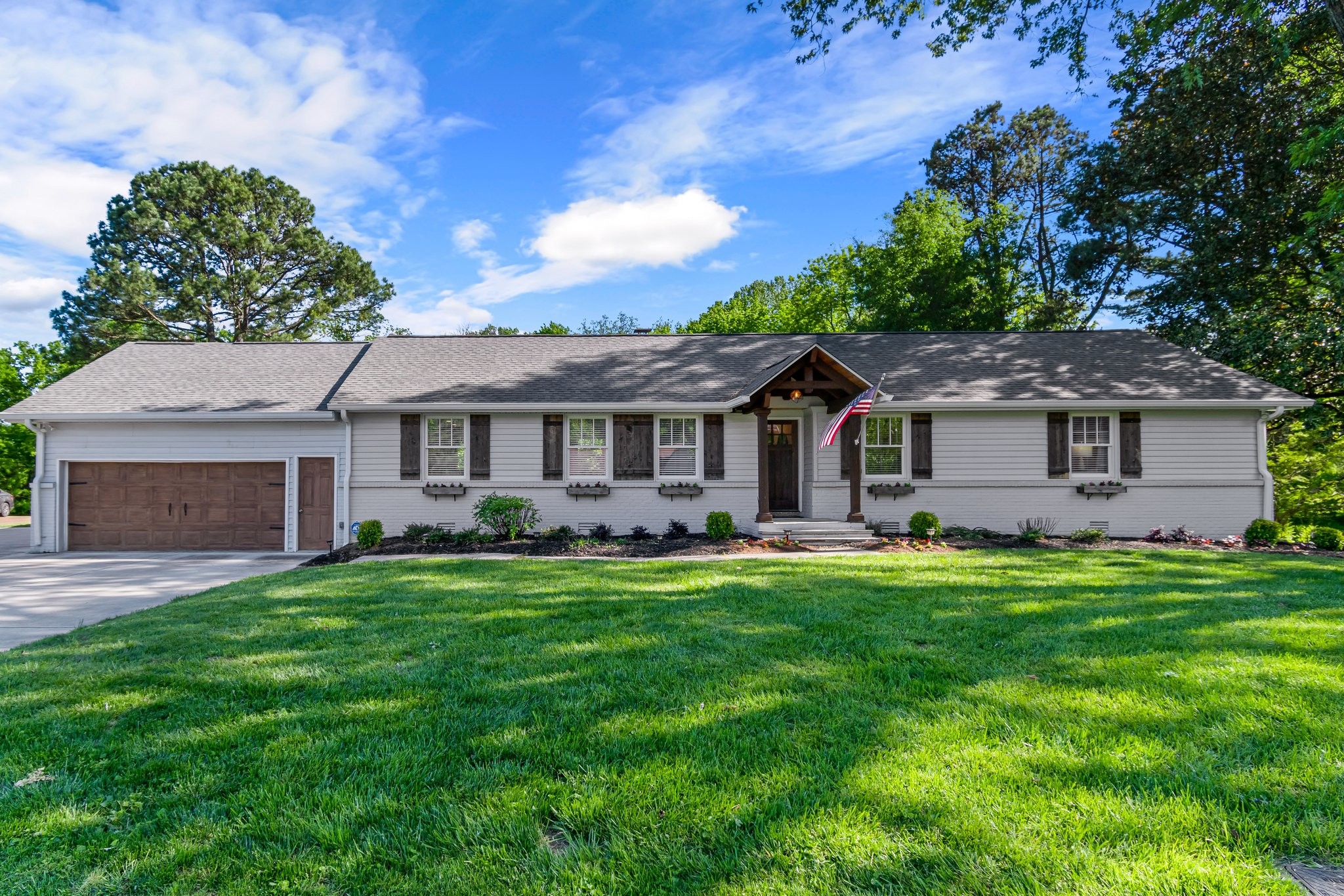 183 Lancaster Drive Franklin, TN 37064 - Photo 2 of 39 a front view of a house with a garden
