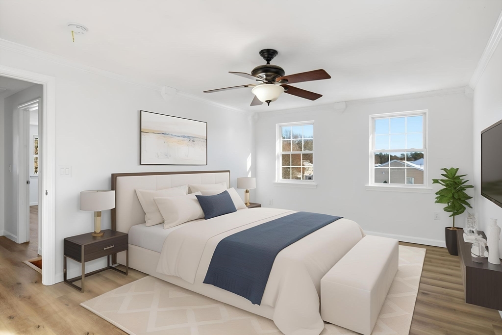 22 Pheasant Drive Springfield, MA 01119 - Photo 25 of 40 a bedroom with a large bed and a chandelier