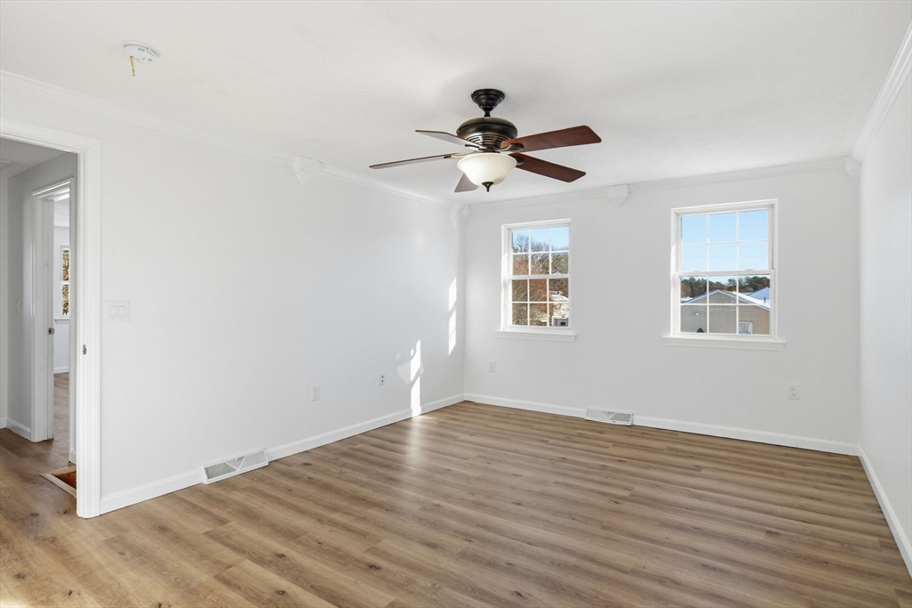 22 Pheasant Drive Springfield, MA 01119 - Photo 26 of 40 a view of empty room with wooden floor and fan