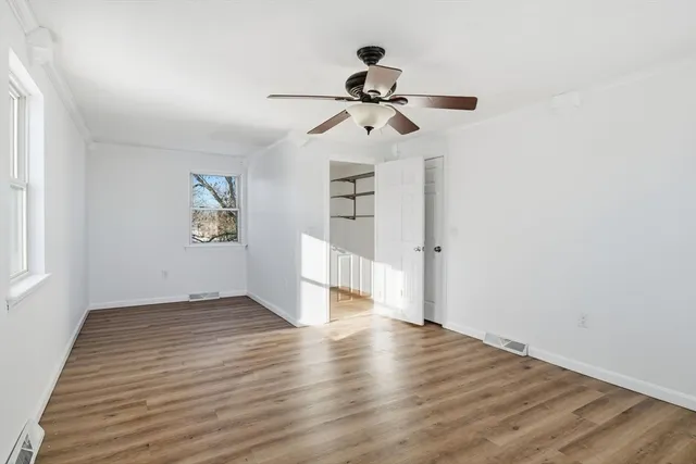 a view of a room with wooden floor