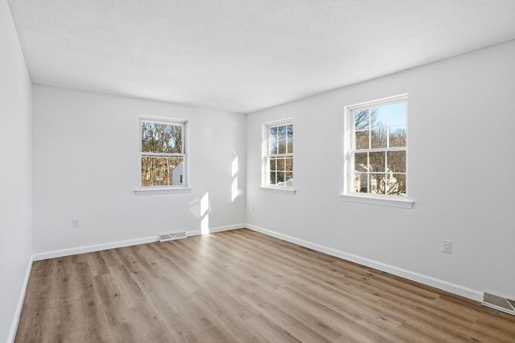 22 Pheasant Drive Springfield, MA 01119 - Photo 32 of 40 a view of empty room with wooden floor and fan