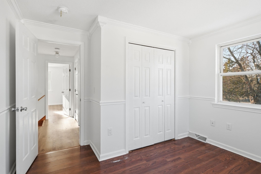 22 Pheasant Drive Springfield, MA 01119 - Photo 34 of 40 an empty room with wooden floor and windows