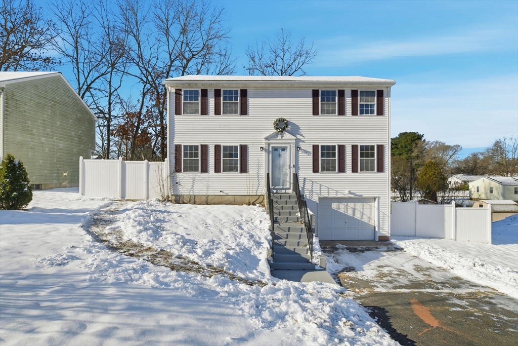 22 Pheasant Drive Springfield, MA 01119 - Photo 8 of 40 a front view of a house with a yard covered in snow