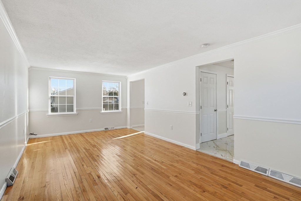 22 Pheasant Drive Springfield, MA 01119 - Photo 10 of 40 a view of empty room with wooden floor and fan