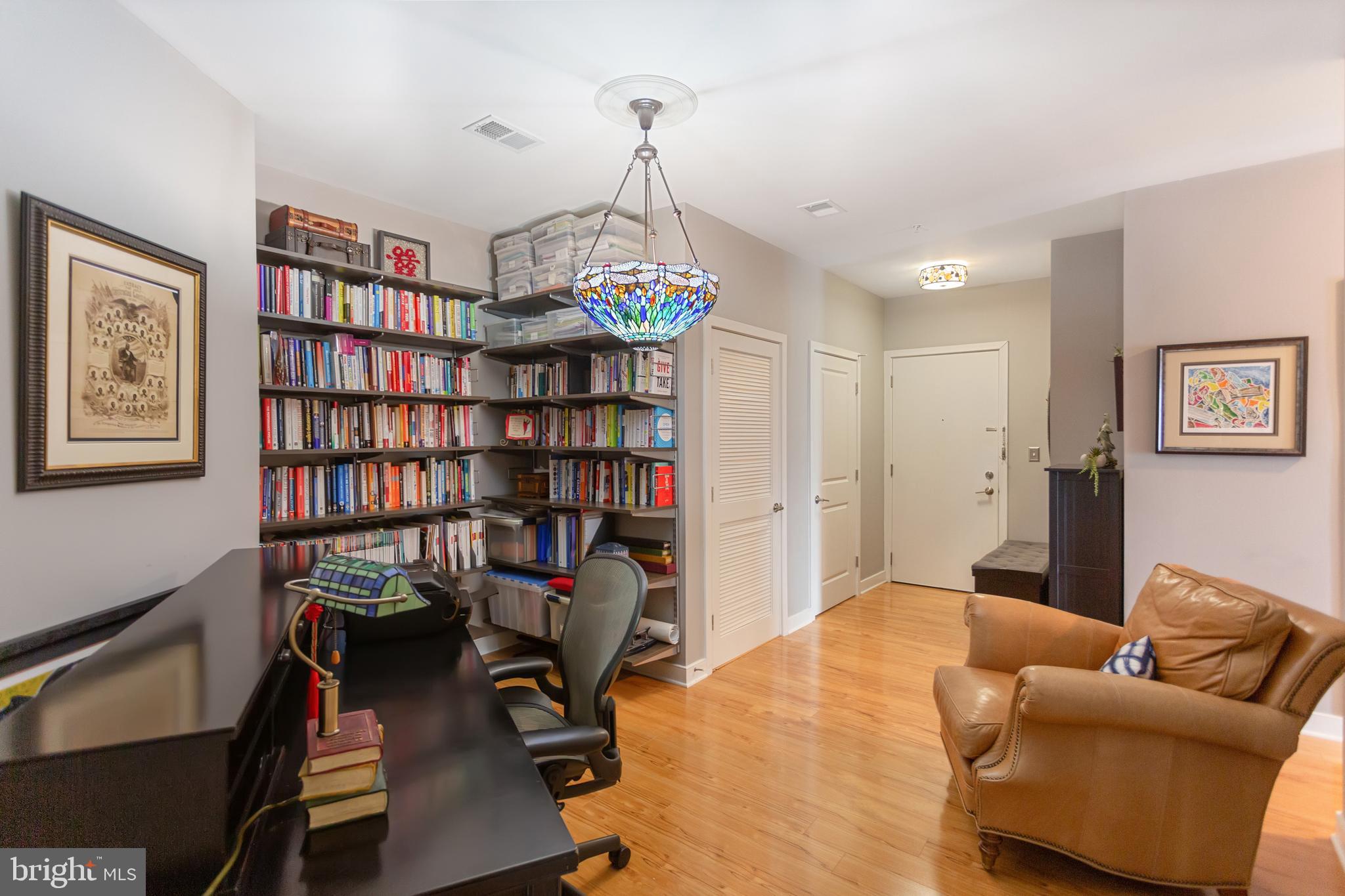 8005 13th Street, Unit 305 Silver Spring, MD 20910 - Photo 11 of 40 a view of a livingroom with workspace and a couch