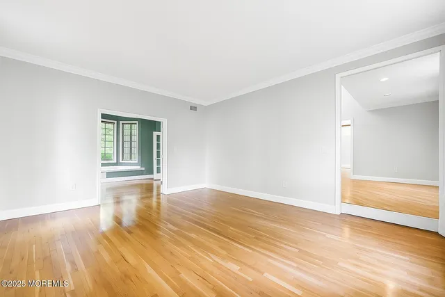 a view of a dining room with furniture and a chandelier