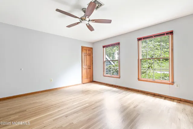 a bedroom with a large bed and potted plant
