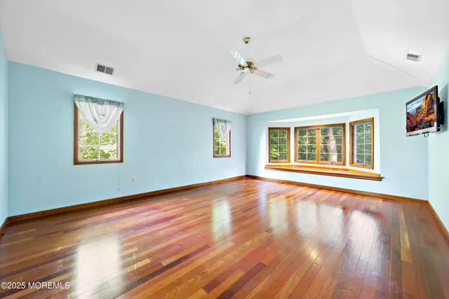 a room with pool table and windows
