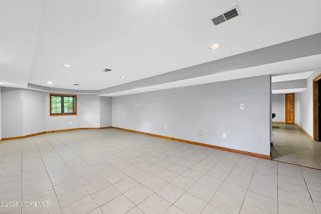 a view of a big yard with plants and large trees