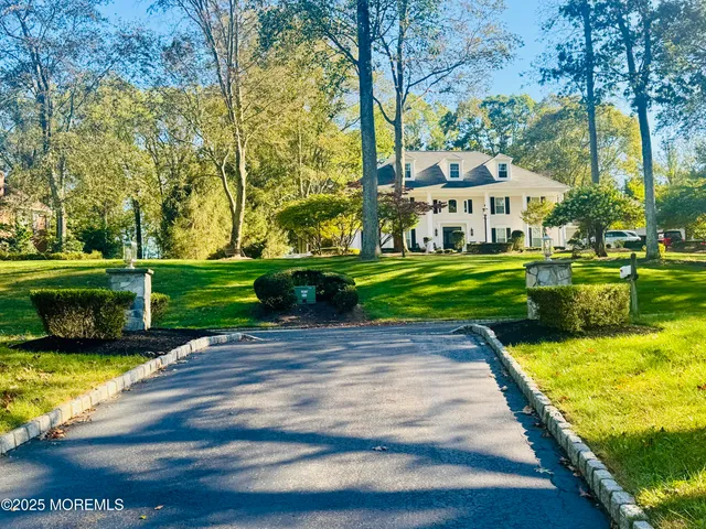 a front view of house with yard and green space