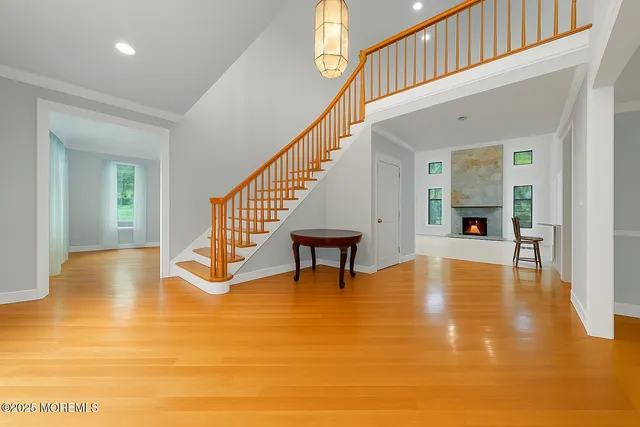 a view of an empty room with a fireplace and a window