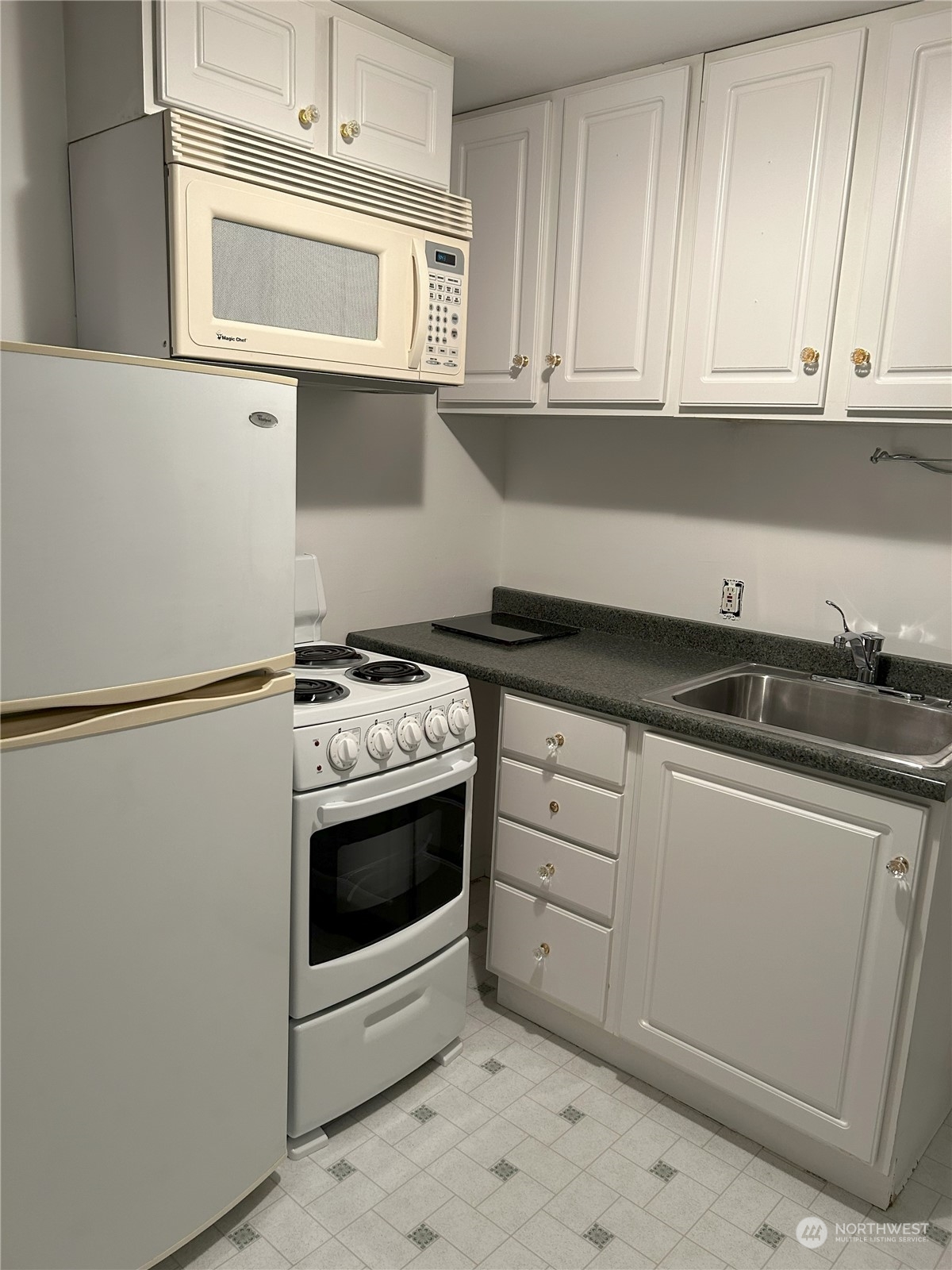 2515 Belvidere Avenue Southwest Seattle, WA 98126 - Photo 25 of 39 a kitchen with stainless steel appliances granite countertop a sink and a refrigerator