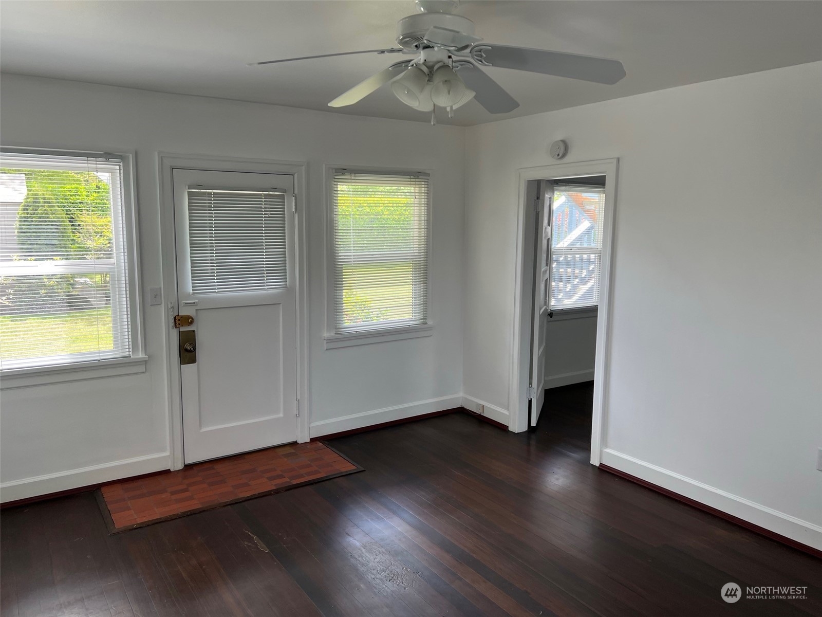 2515 Belvidere Avenue Southwest Seattle, WA 98126 - Photo 28 of 39 an empty room with wooden floor closet and windows