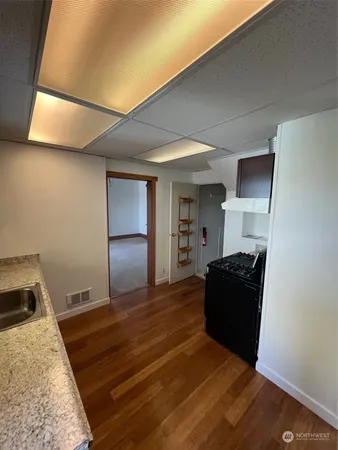 a living room with a couch and a stove next to a window