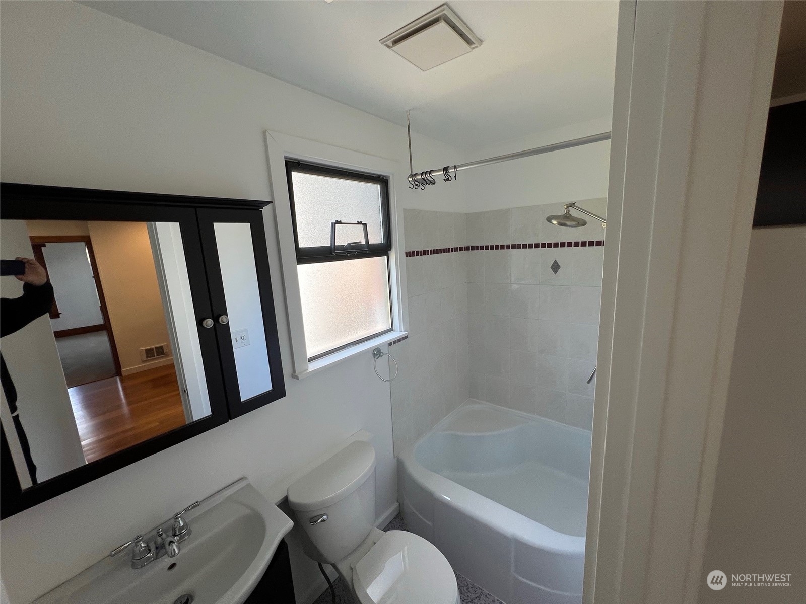 2515 Belvidere Avenue Southwest Seattle, WA 98126 - Photo 36 of 39 a bathroom with a tub toilet a sink and mirror