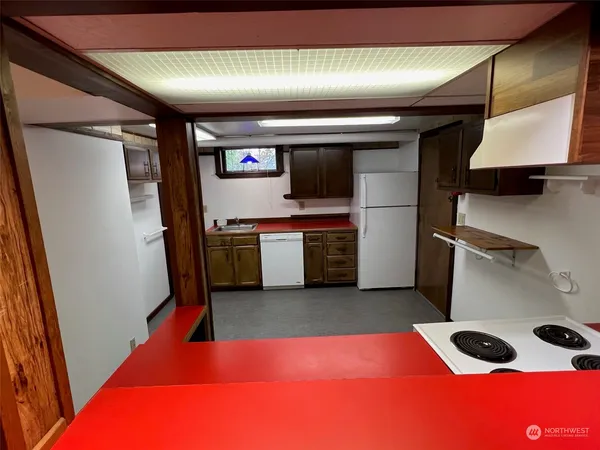 a kitchen with stainless steel appliances kitchen island a sink and refrigerator