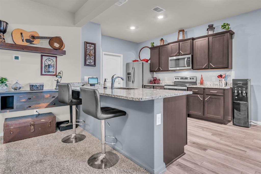 189 Point Rider Road Newark, TX 76071 - Photo 12 of 40 a kitchen with cabinets a sink and appliances