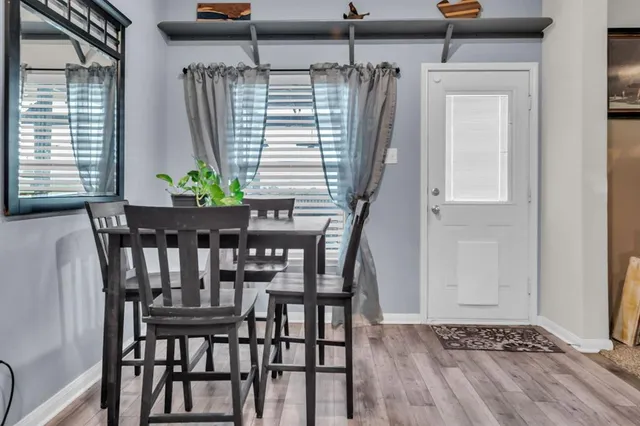 a view of a dining room with furniture and window