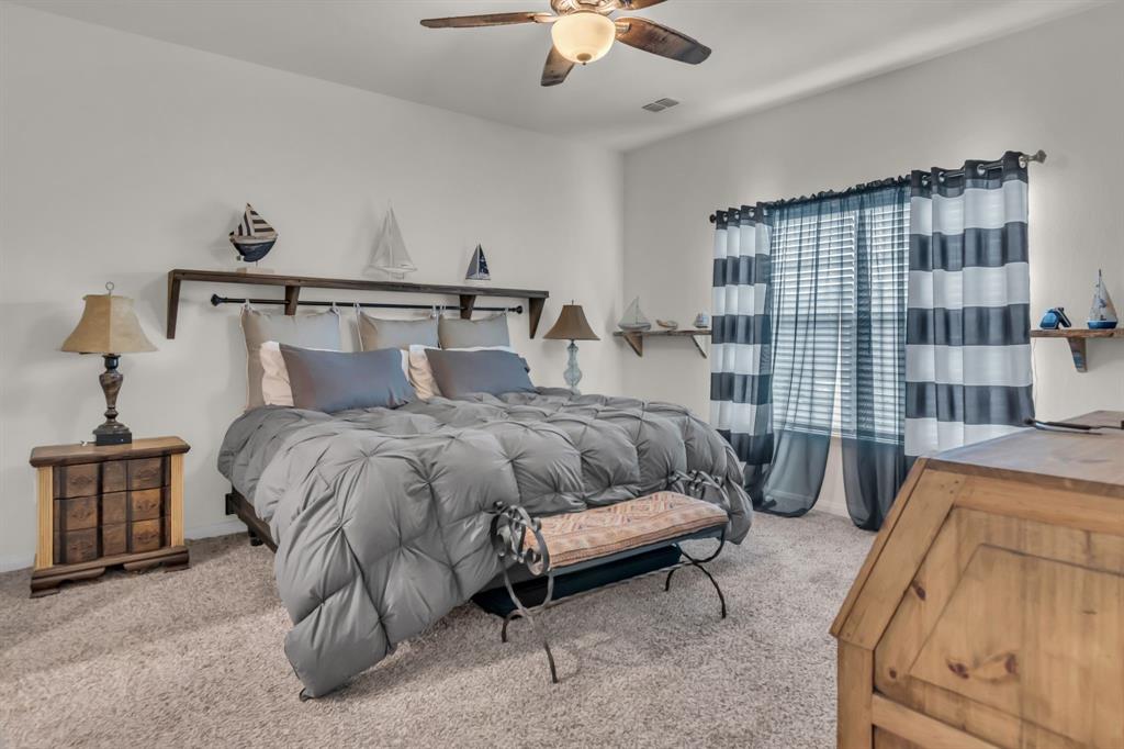 189 Point Rider Road Newark, TX 76071 - Photo 17 of 40 a bedroom with a bed and a couch