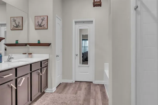 a bathroom with a sink a mirror and a shower