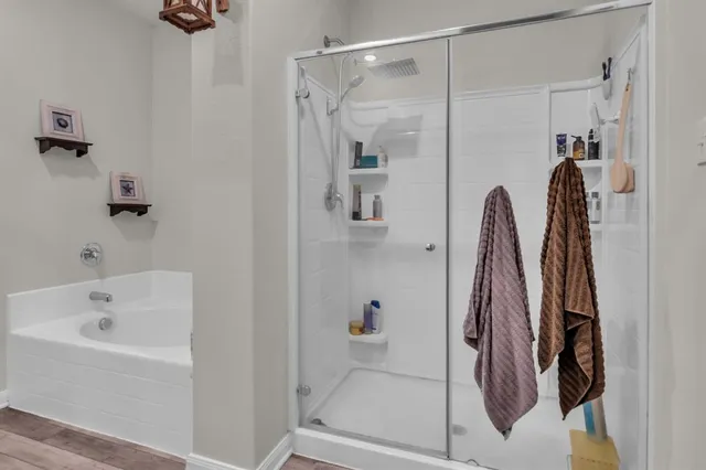 a bathroom with a bathtub and a shower