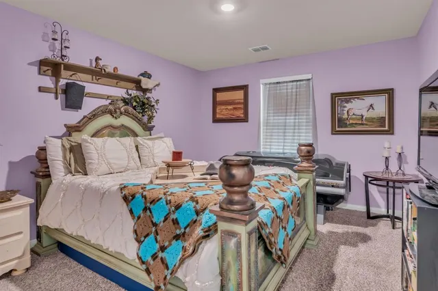 a bedroom with bed and window