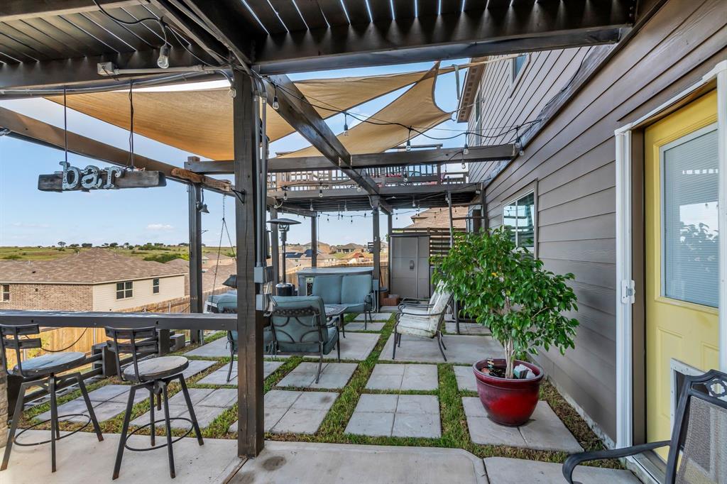 189 Point Rider Road Newark, TX 76071 - Photo 30 of 40 a view of a patio with table and chairs potted plants