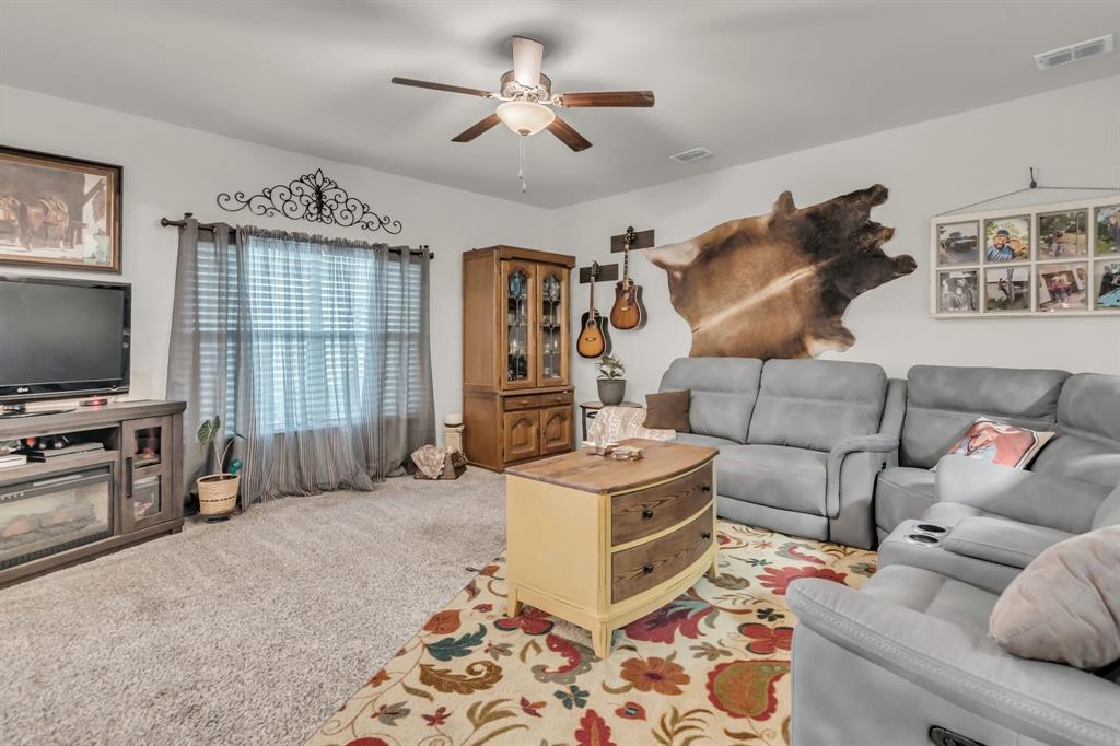 189 Point Rider Road Newark, TX 76071 - Photo 7 of 40 a living room with furniture and a flat screen tv