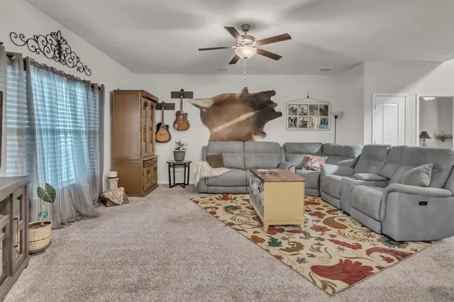 a living room with furniture and a rug