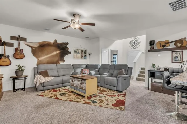 a living room with furniture and a chandelier