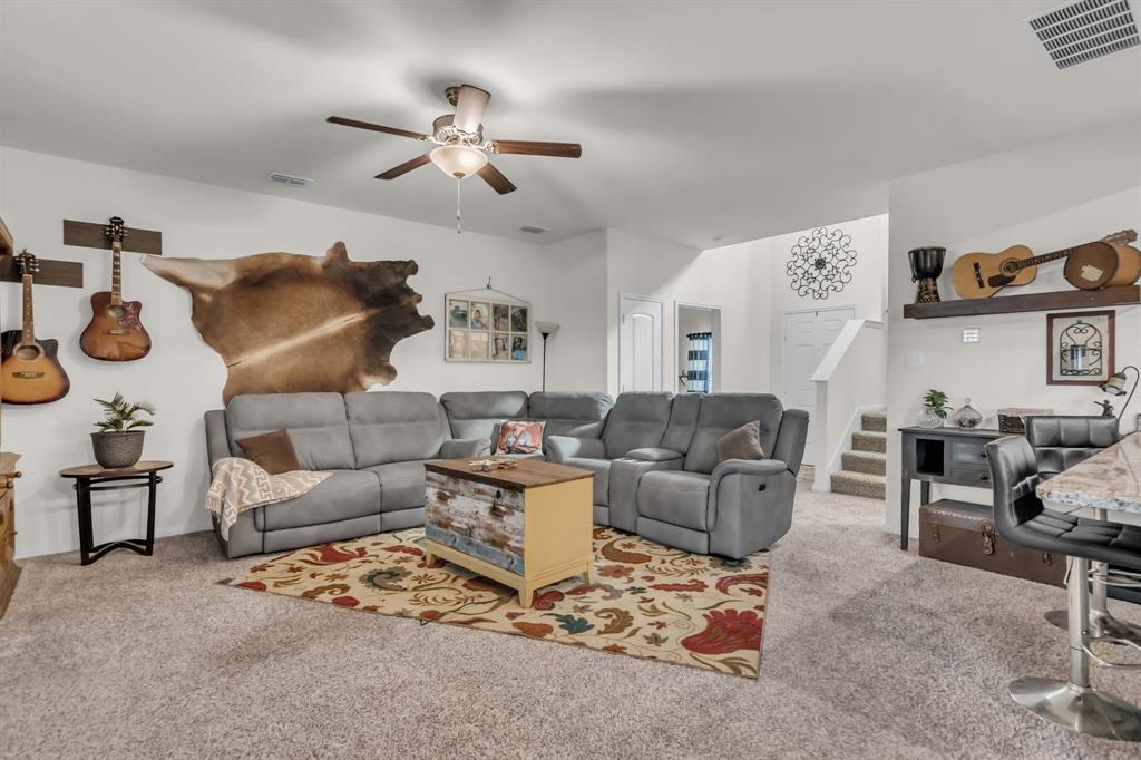 189 Point Rider Road Newark, TX 76071 - Photo 9 of 40 a living room with furniture and a chandelier