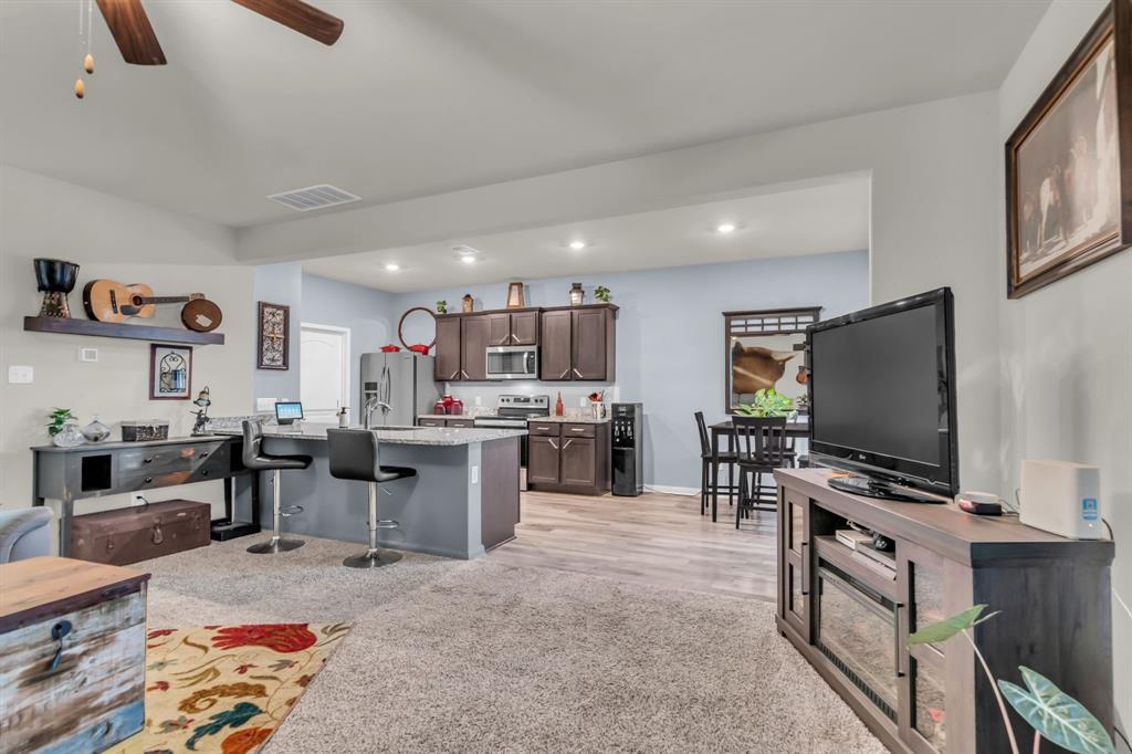 189 Point Rider Road Newark, TX 76071 - Photo 10 of 40 a living room with furniture and a flat screen tv