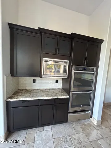 a kitchen with a sink and a mirror
