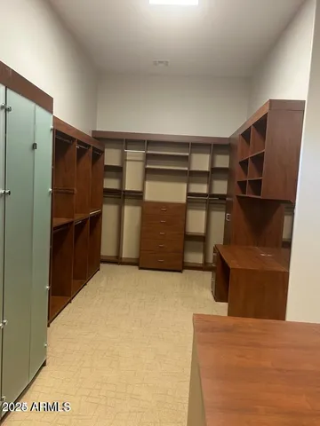 a view of an empty room with wooden cabinet