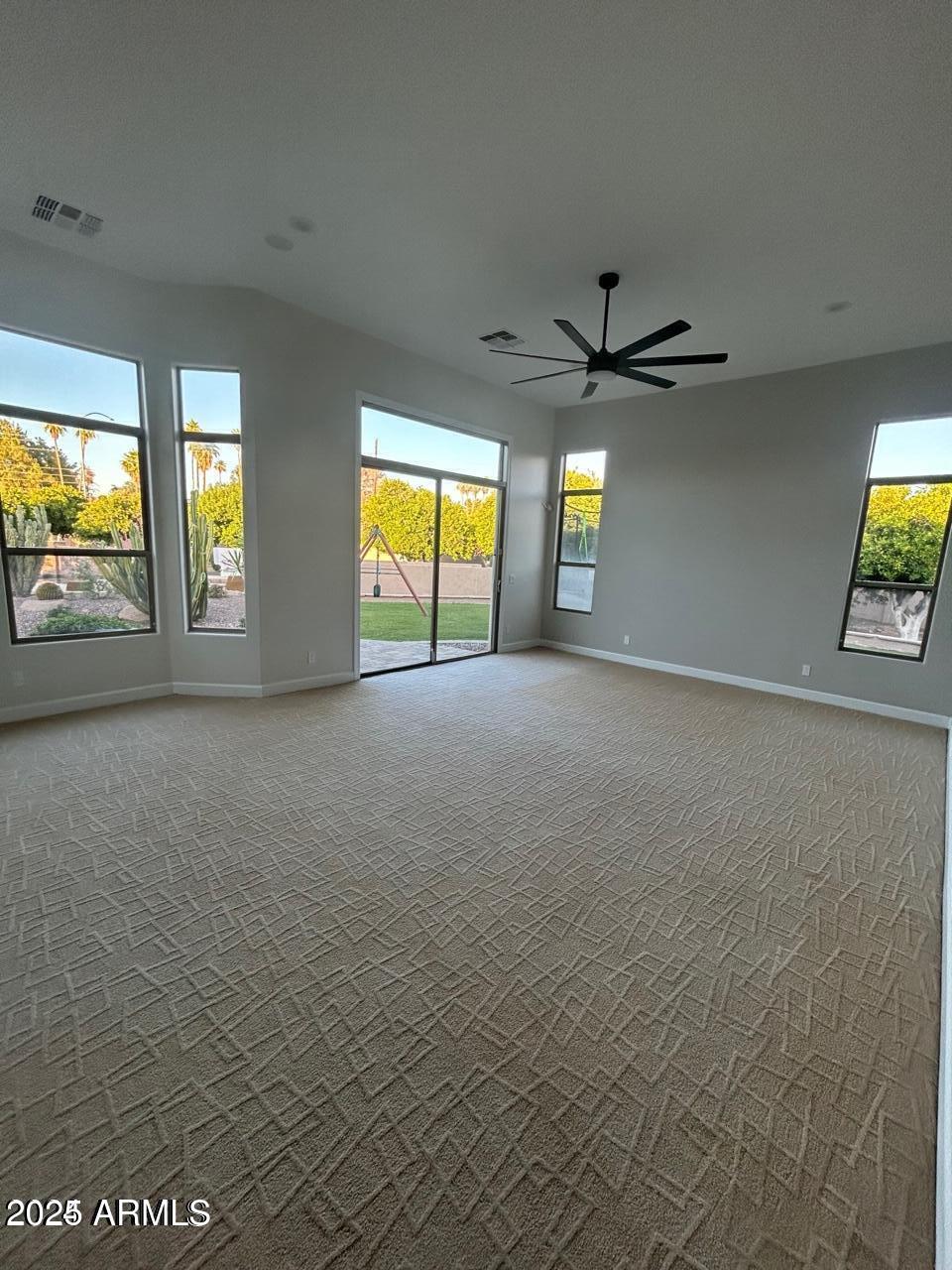 3552 East Jaeger Circle Mesa, AZ 85213 - Photo 19 of 21 an empty room with windows and ceiling fan