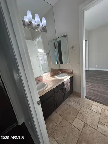 a bathroom with a sink a vanity and a mirror