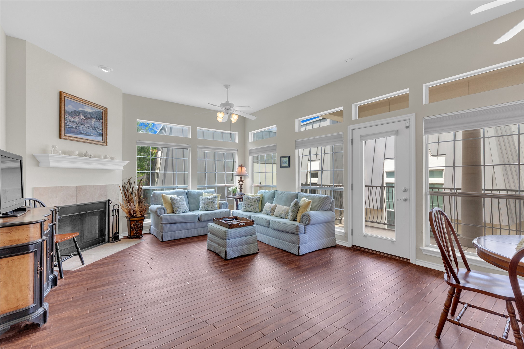 2918 Ranch Road 620 North, Unit L173 Austin, TX 78734 - Photo 2 of 35 Living room featuring ceiling fan, hardwood / wood-style flooring, and a tiled fireplace