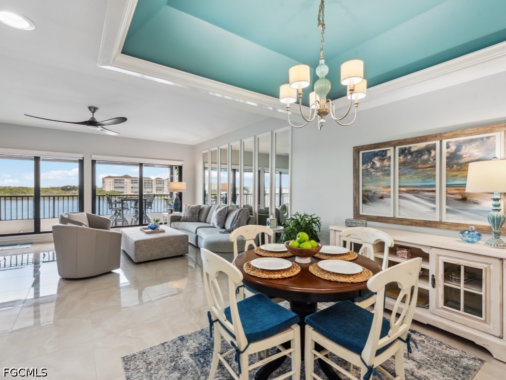 232 La Peninsula Boulevard, Unit 232 Naples, FL 34113 - Photo 8 of 44 a view of a dining room with furniture window and outside view