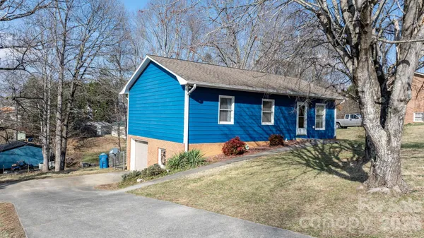 a view of a house with a yard covered in snow