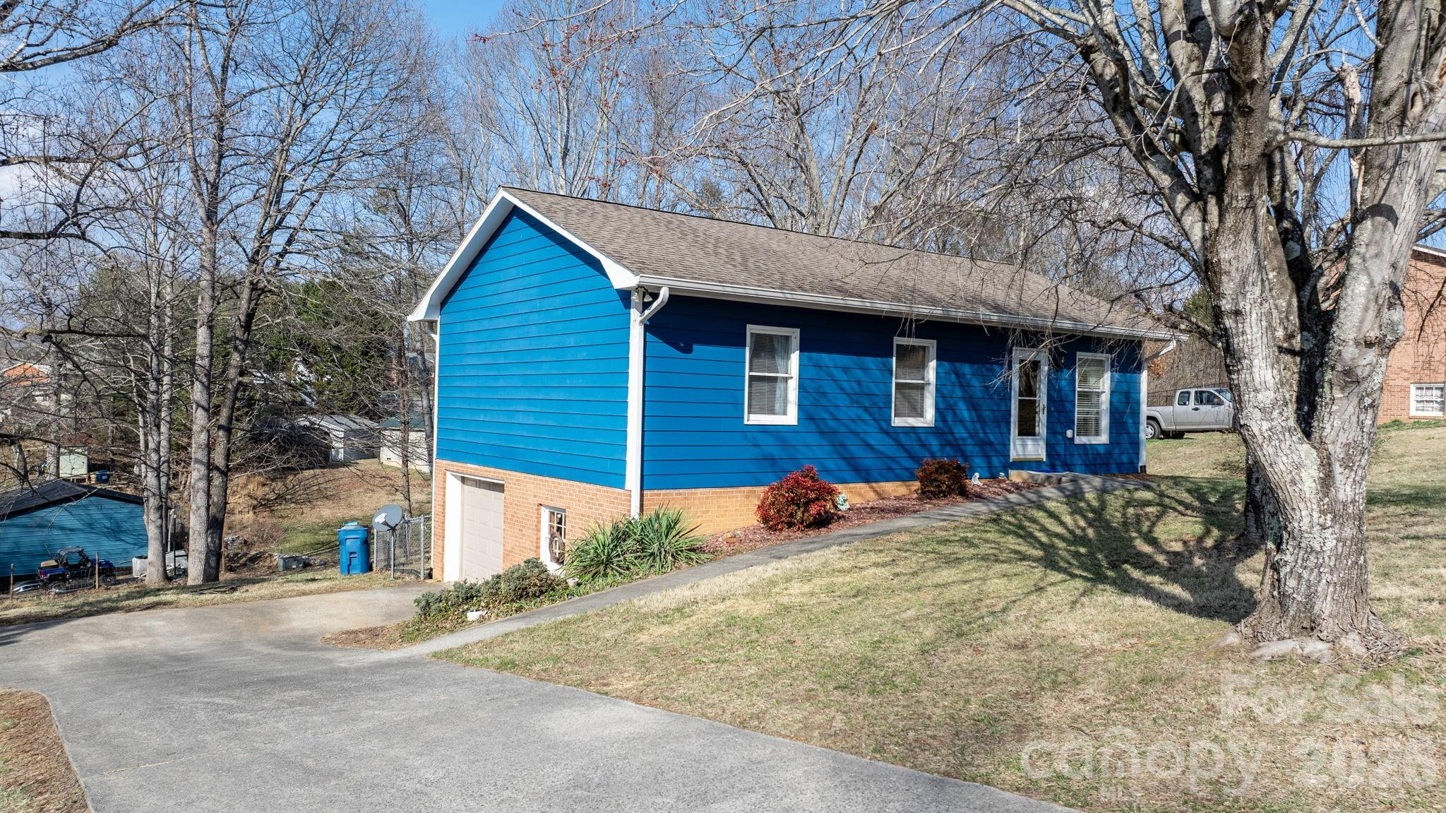 a view of a house with a yard covered in snow
